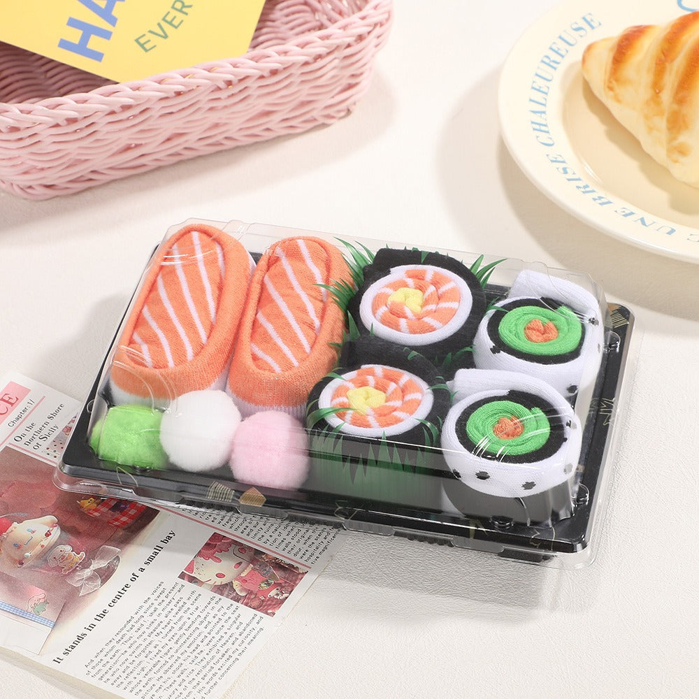 Sushi socks in a takeaway tray on a kitchen counter