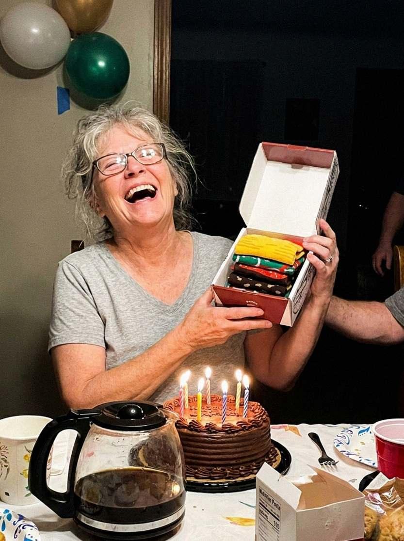 Grandma laughing as she opens the sock box (AI-generated illustration)